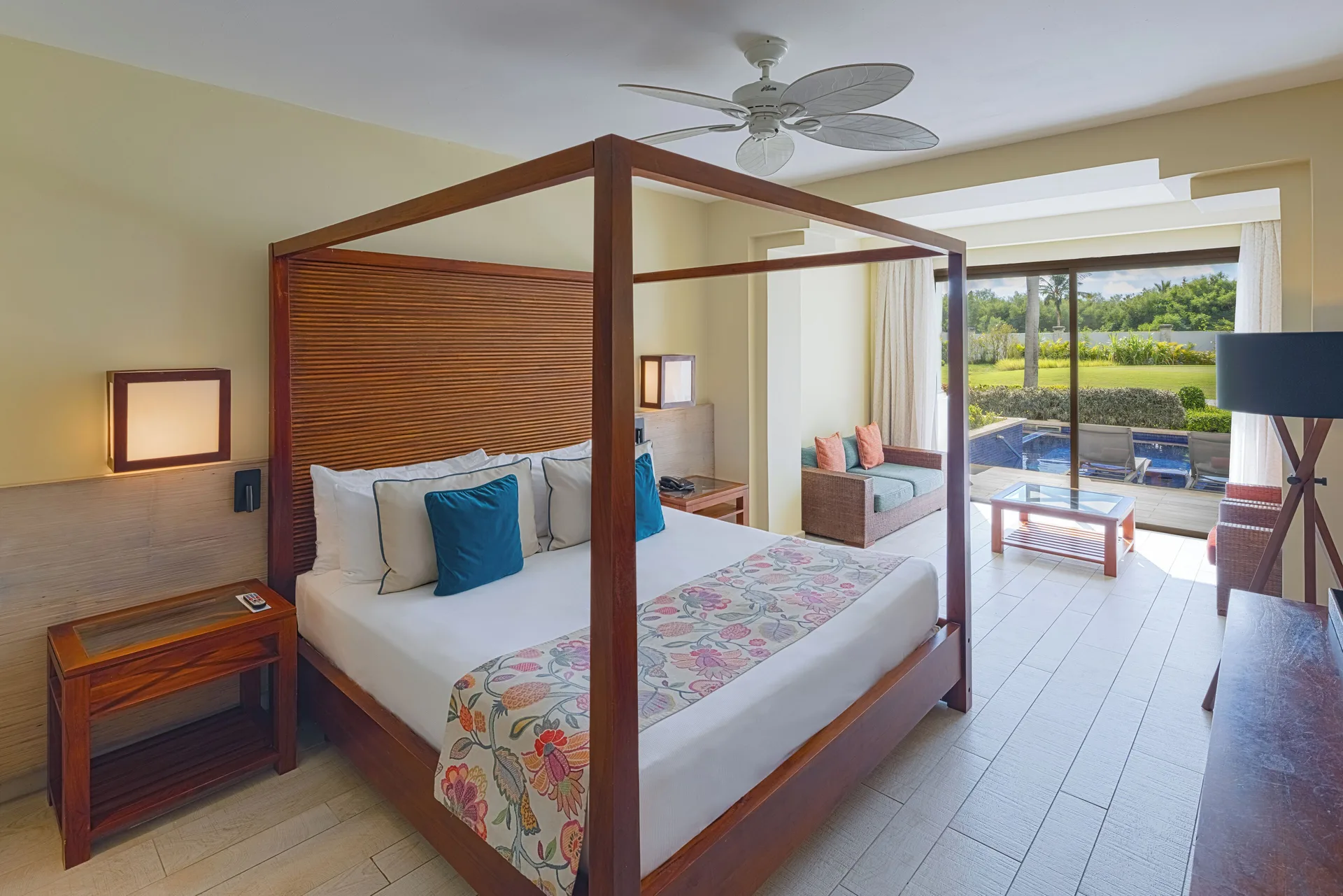 Guest room with four-poster king bed and swim-up terrace at Catalonia Royal Bavaro.