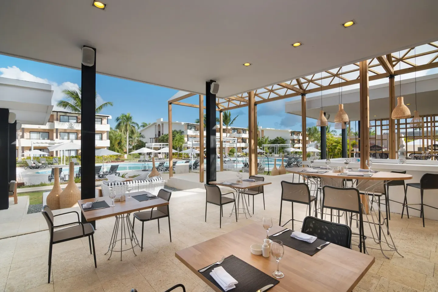 An open-air restaurant terrace overlooks the pool at Catalonia Royal Bavaro.