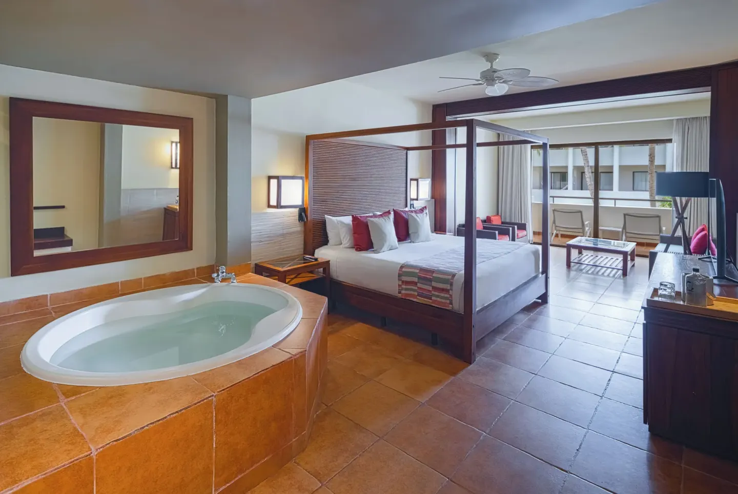 Privileged Deluxe Junior Suite with four-poster bed and soaking tub at Catalonia Royal Bavaro.