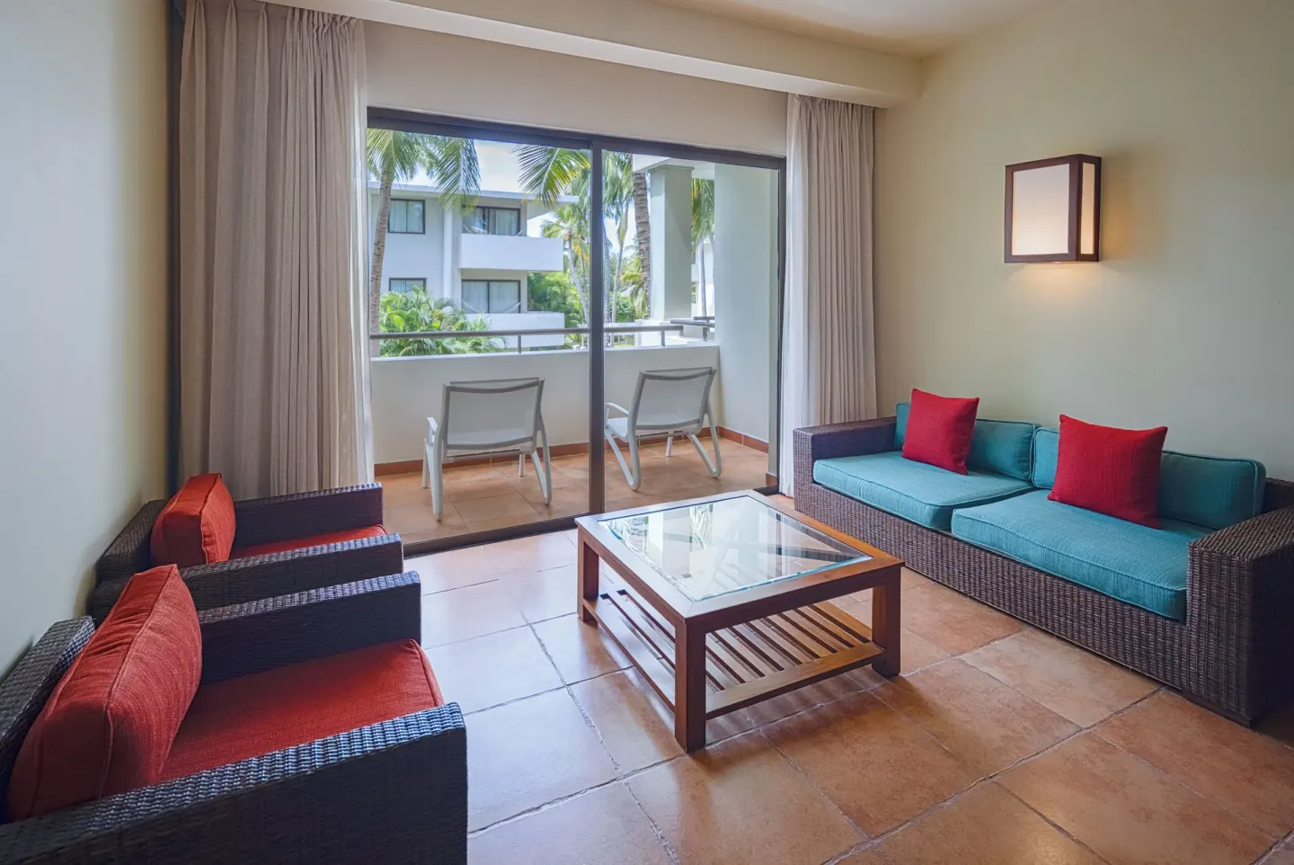 Privileged Deluxe Junior Suite sitting area with balcony access at Catalonia Royal Bavaro.