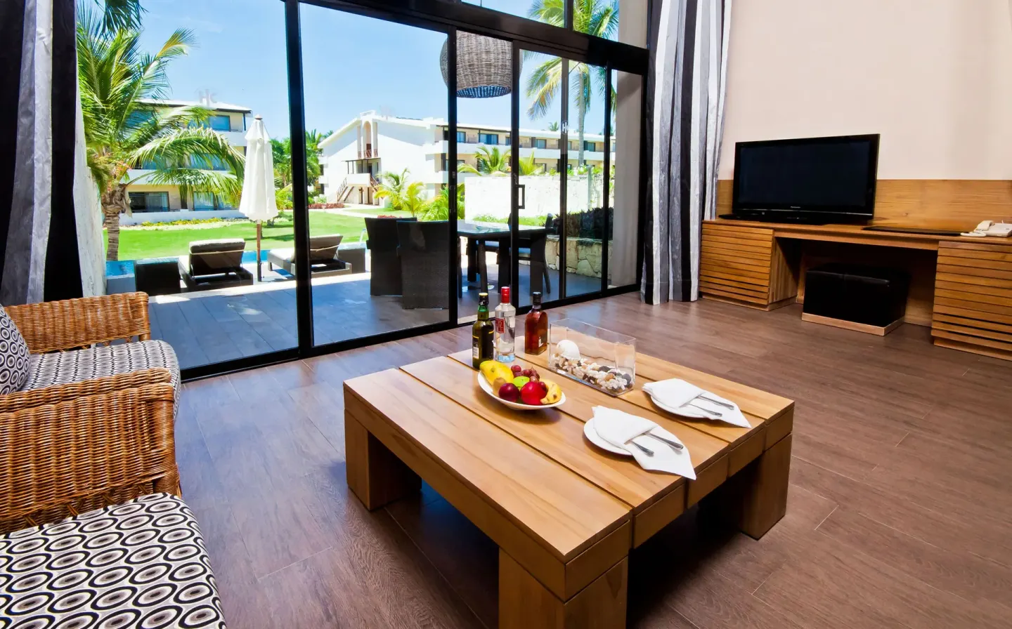 Privileged Duplex Suite lounge with terrace doors at Catalonia Royal Bavaro.