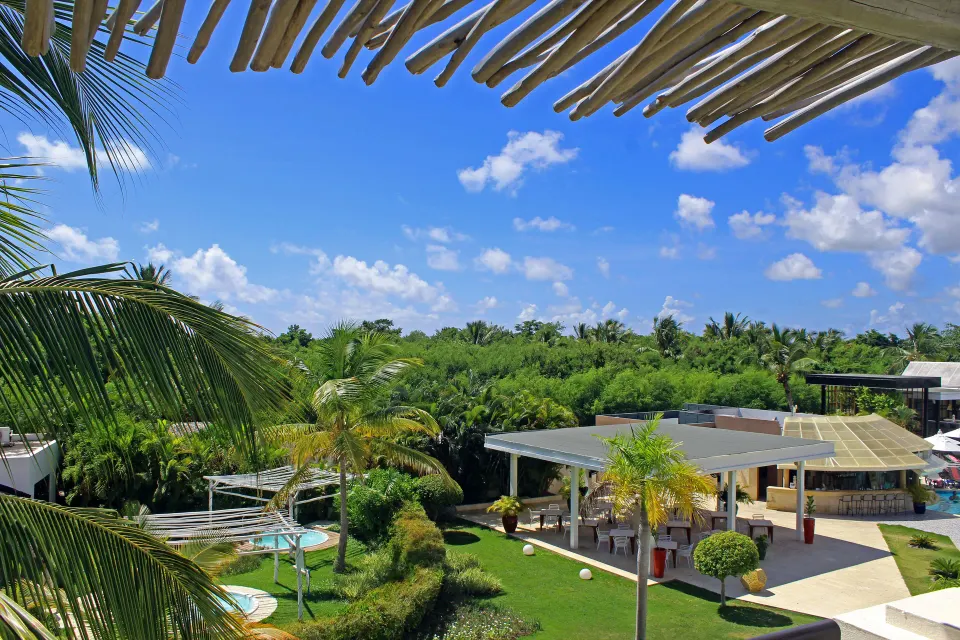 Superior Junior Suite balcony view of palms and gardens at Catalonia Royal Bavaro.