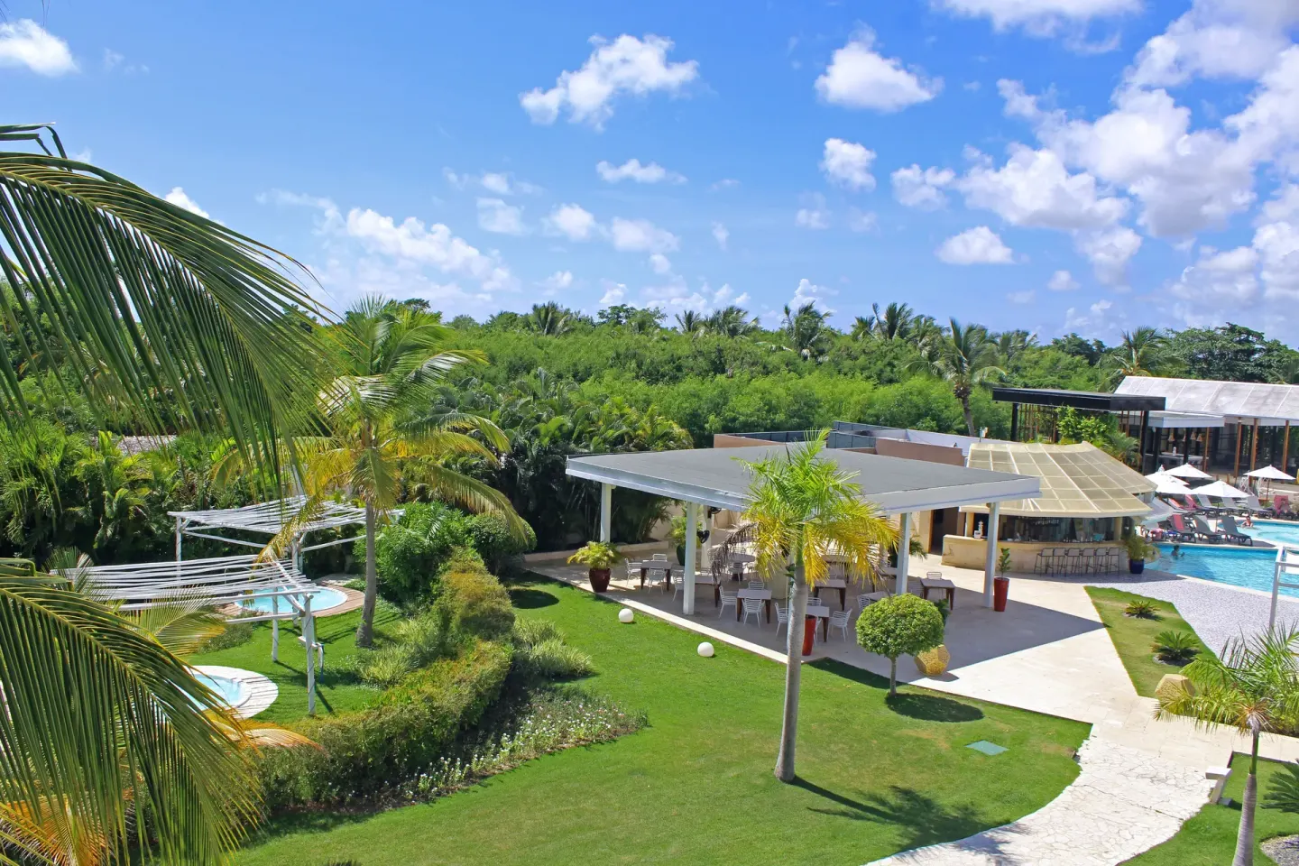 Superior Junior Suite balcony view of lawn and pool area at Catalonia Royal Bavaro.