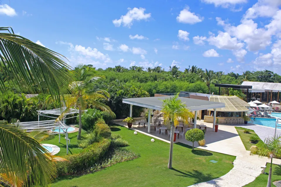 Superior Junior Suite balcony view of lawn and pool area at Catalonia Royal Bavaro.