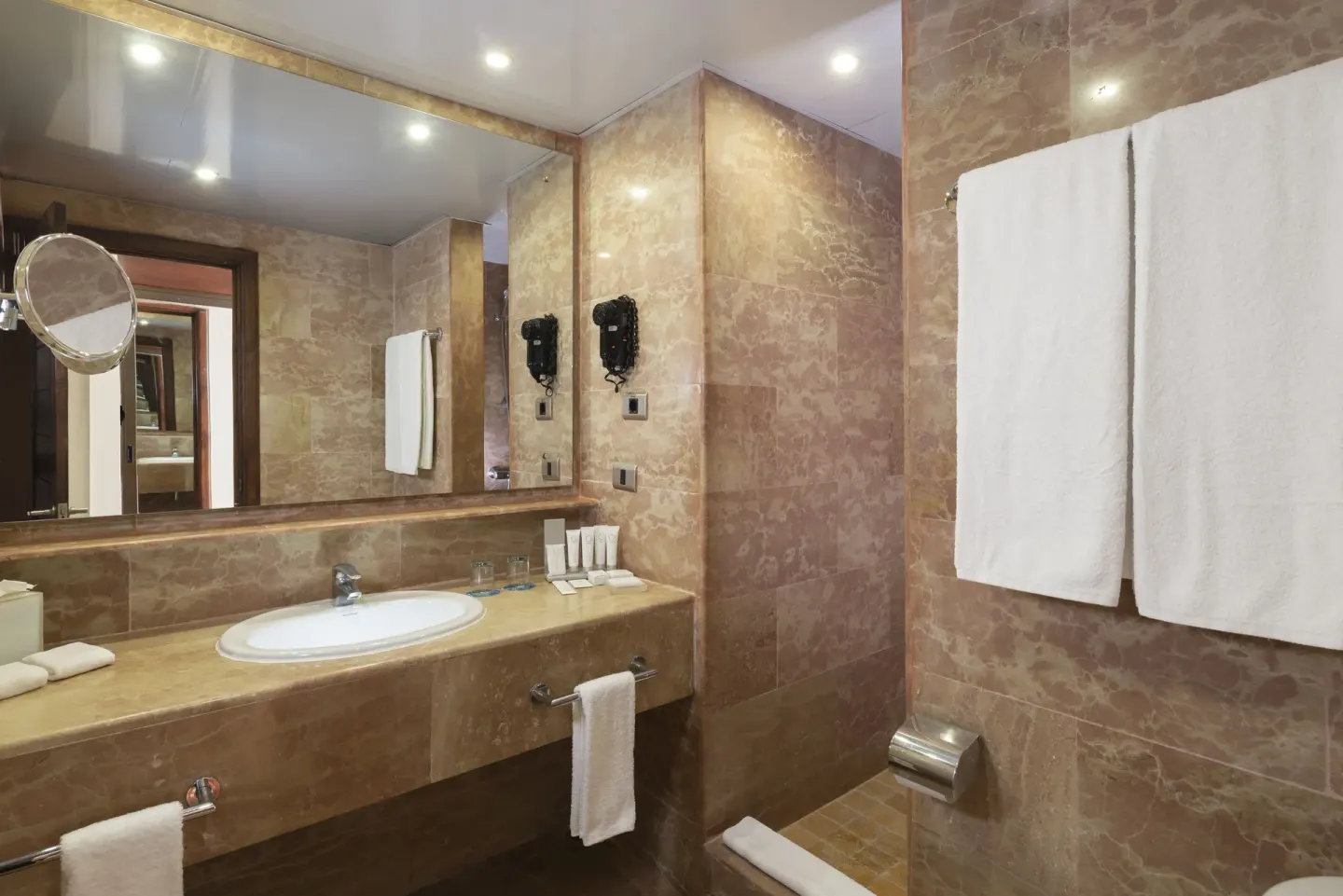 Superior Junior Suite bathroom with vanity and towels at Catalonia Royal Bavaro.