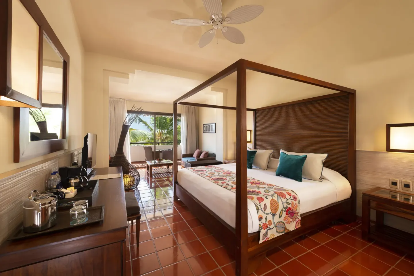 Superior Junior Suite with canopy bed and balcony seating at Catalonia Royal Bavaro.