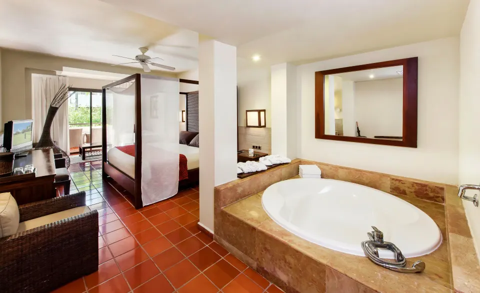 Superior Junior Suite with canopy bed and round tub at Catalonia Royal Bavaro.