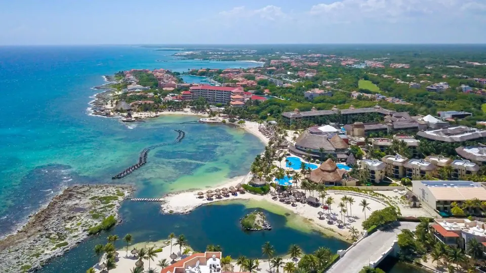 Aerial view of Catalonia Yucatan Beach resort showing coastline, pools and grounds.