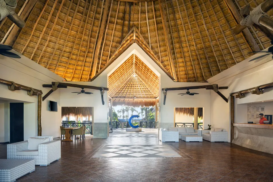 Resort reception area with high thatched ceiling at Catalonia Yucatan Beach