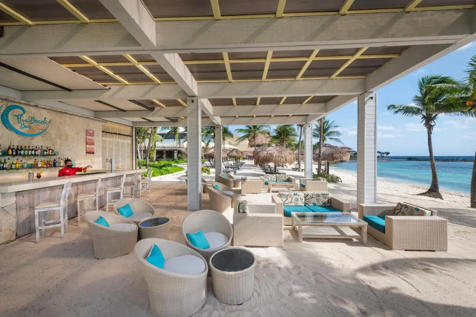 Beachfront lounge and bar seating on the sand at Catalonia Yucatan Beach.