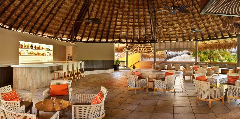 Open palapa bar and lounge overlooking gardens at Catalonia Yucatan Beach