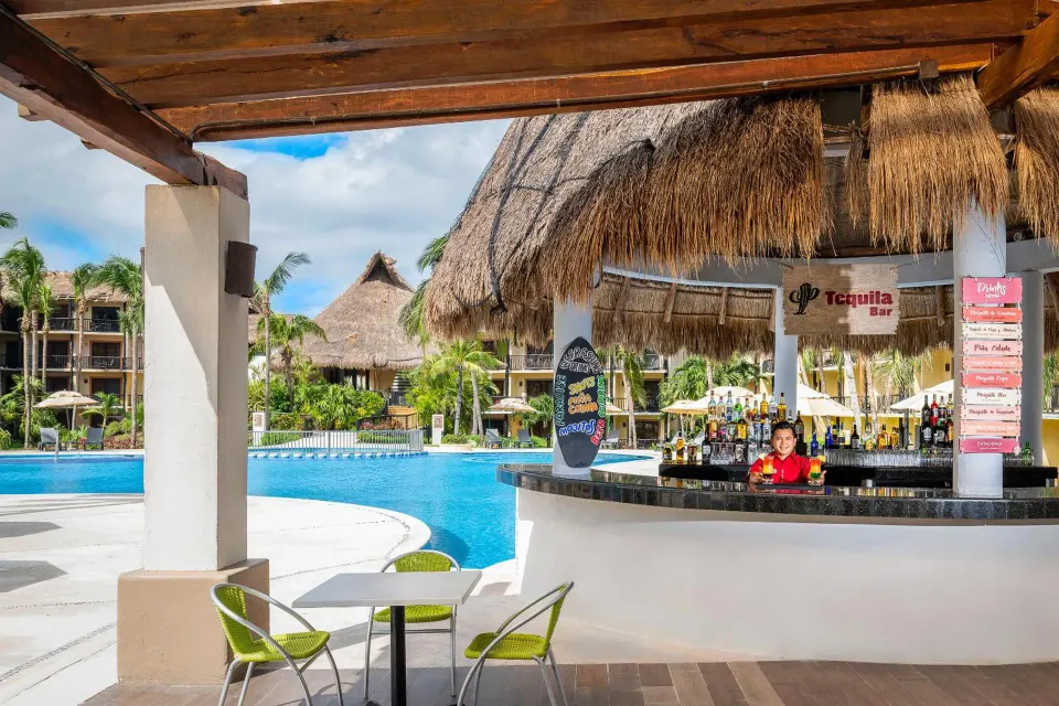 Poolside circular bar with thatched roof at Catalonia Yucatan Beach.