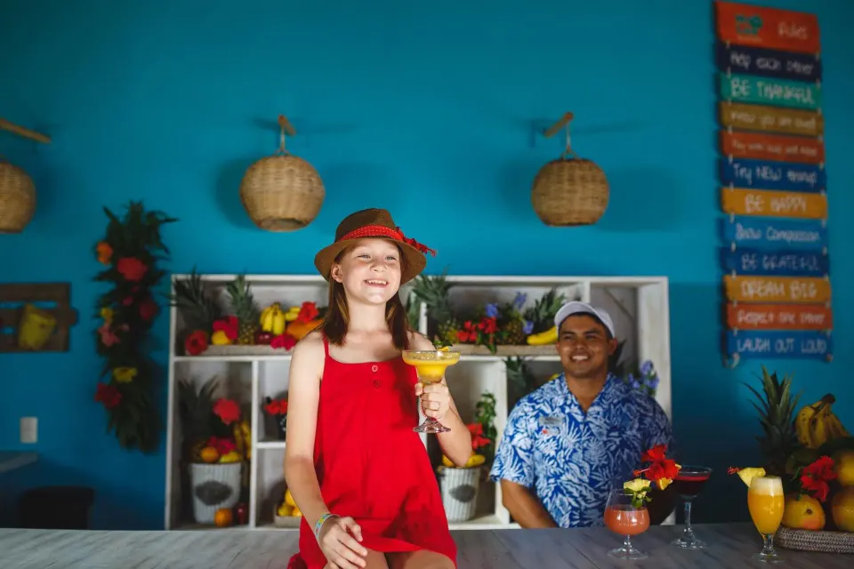 Guest enjoying a tropical drink at the resort bar at Catalonia Yucatan Beach