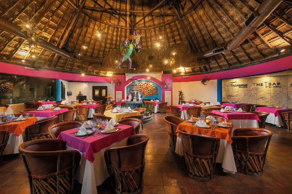 Interior dining room with palapa ceiling and colorful decor at Catalonia Yucatan Beach