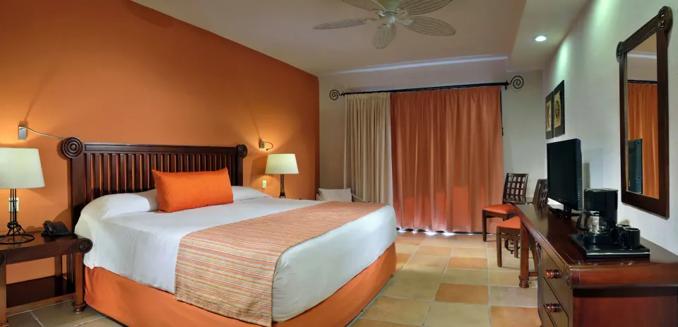 Comfort Room with king bed and warm décor at Catalonia Yucatan Beach