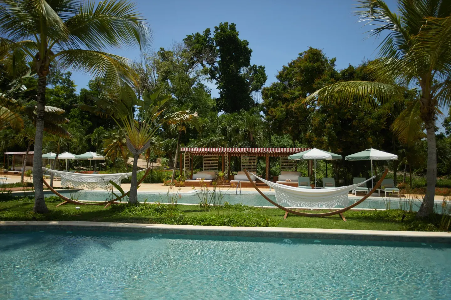 Hammocks and cabanas sit beside a narrow pool at Cayo Levantado Resort.
