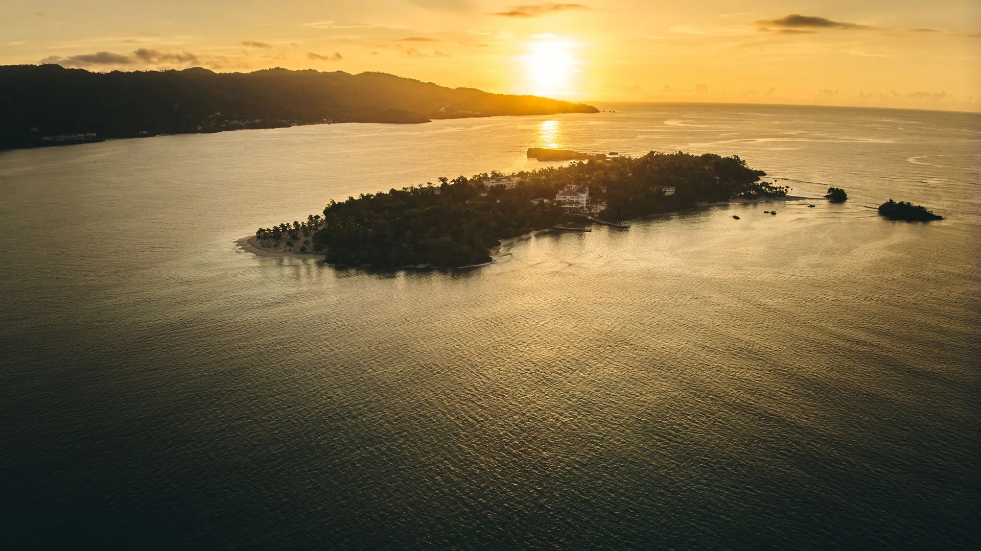 Aerial sunset view of the island and surrounding bay at Cayo Levantado Resort.