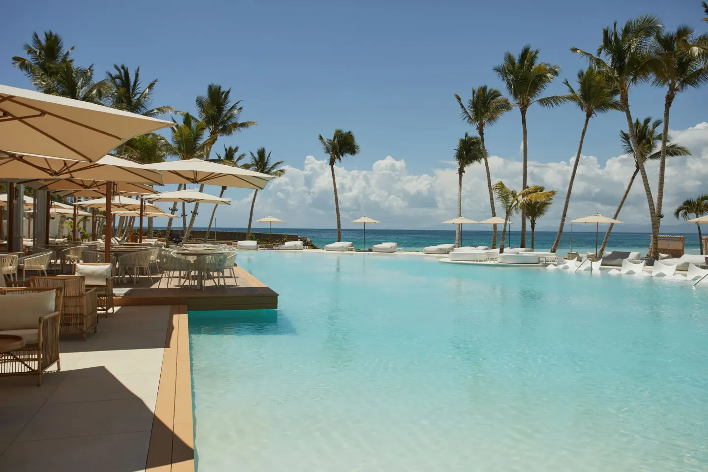 Infinity-style pool with ocean view and shaded seating at Cayo Levantado Resort.