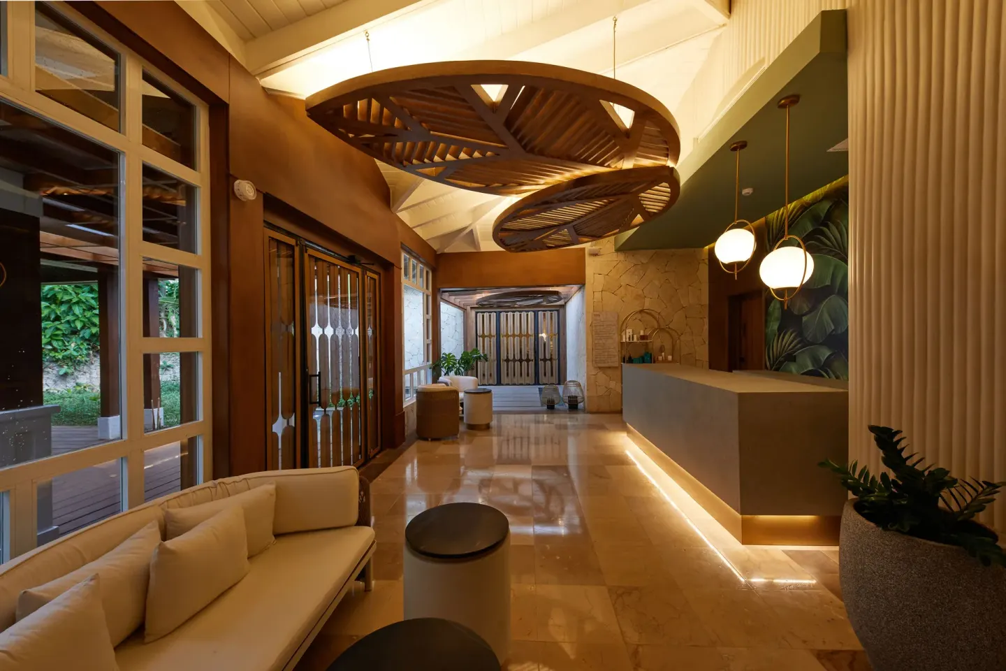 Spa lobby with lounge seating and sculptural wood ceiling at Cayo Levantado Resort.