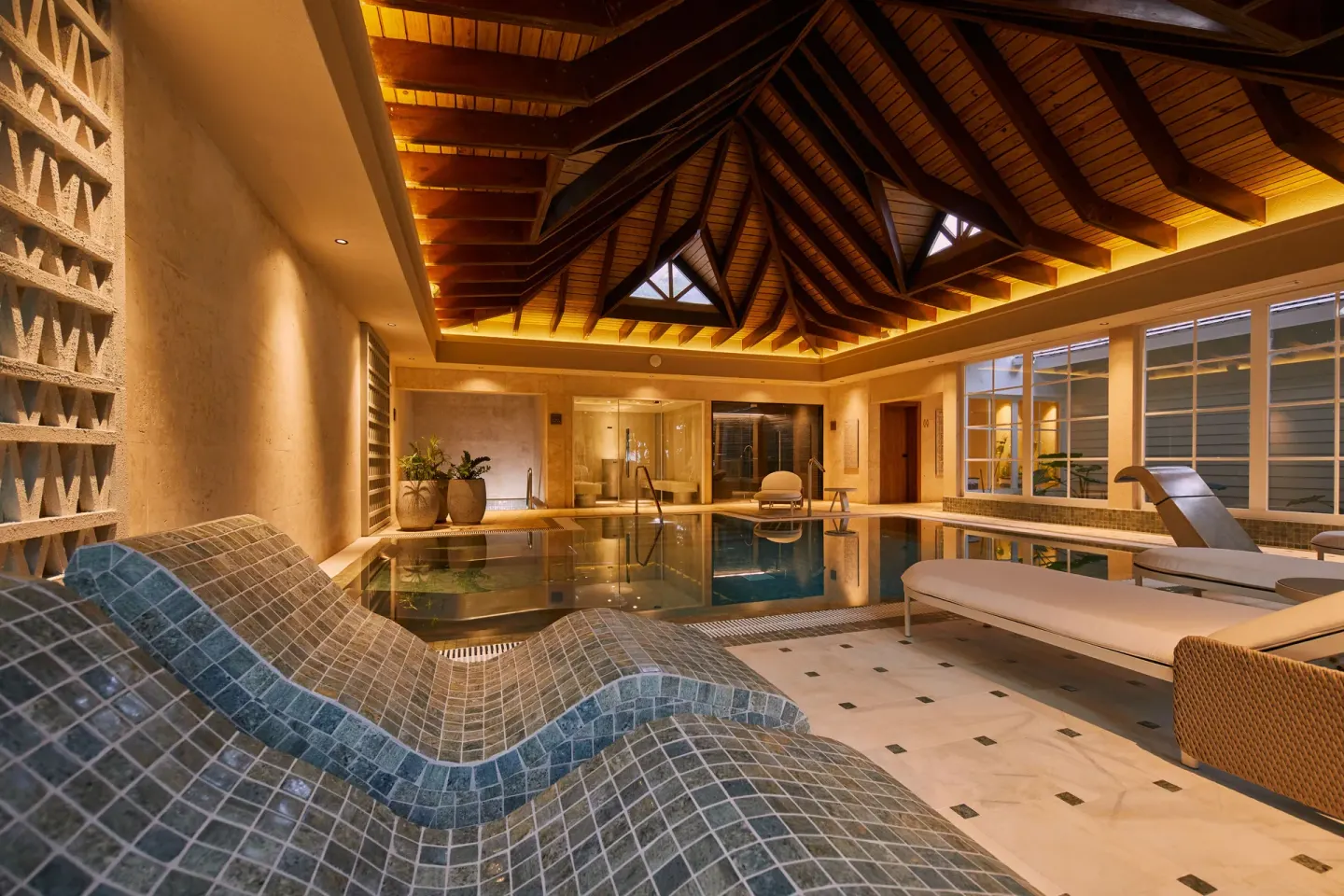 Spa pool room with tiled loungers and daybeds at Cayo Levantado Resort.