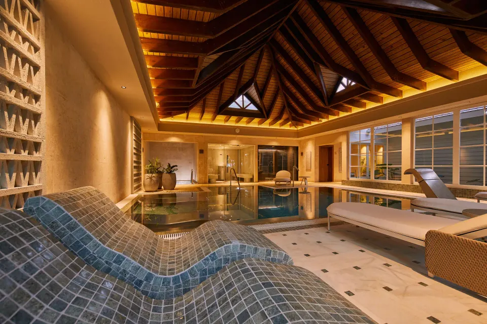 Spa pool room with tiled loungers and daybeds at Cayo Levantado Resort.
