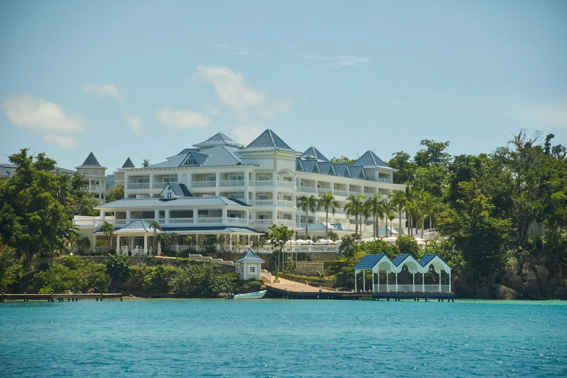 White resort buildings above turquoise water at Cayo Levantado Resort.