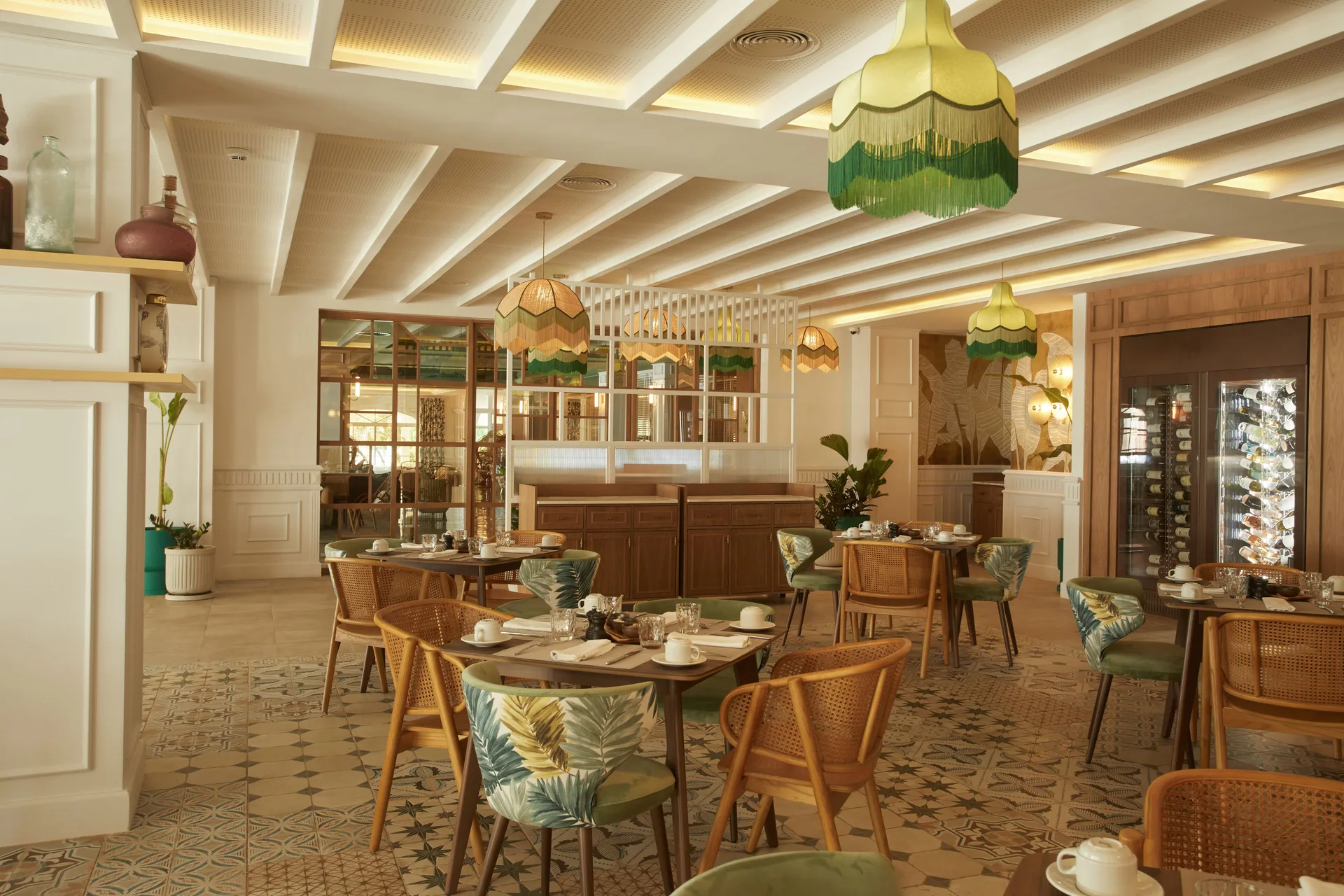Dining room with rattan chairs, green pendant lights, and wine display at Cayo Levantado Resort.