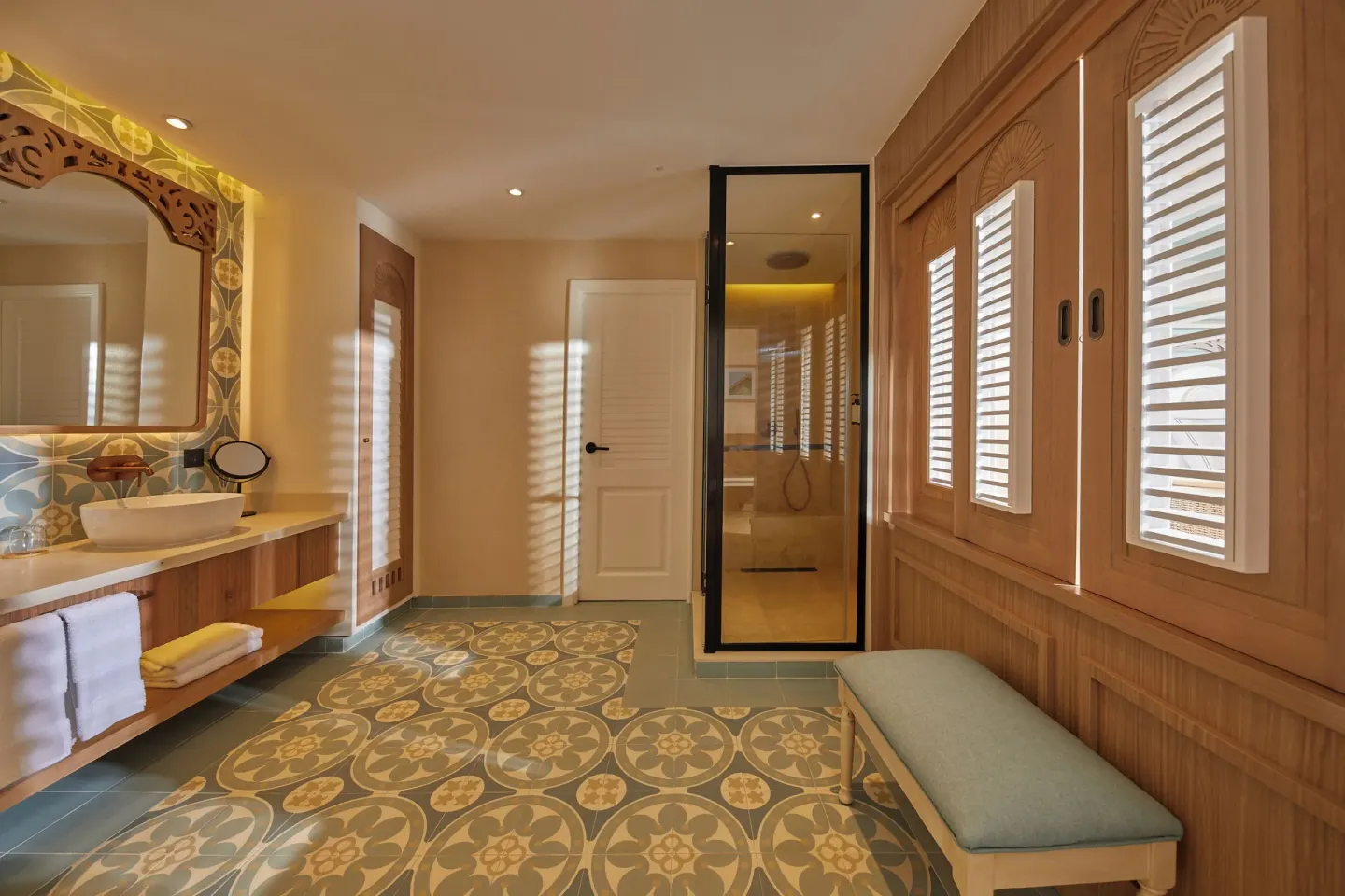 Junior Suite bathroom with vanity, shower, shutters, and patterned tile at Cayo Levantado Resort.