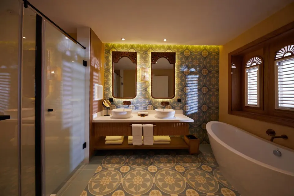 Junior Suite bathroom with soaking tub, shower and twin vanity at Cayo Levantado Resort.