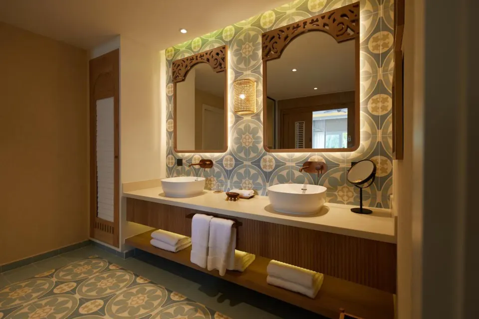Junior Suite bathroom vanity with twin sinks and patterned tile at Cayo Levantado Resort.