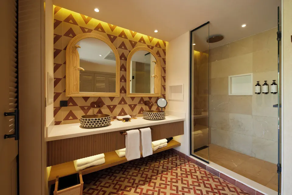 One Bedroom Villa bathroom with double sinks and glass shower at Cayo Levantado Resort.