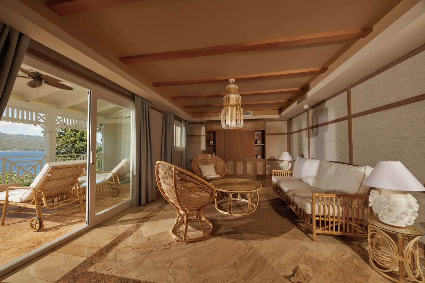 One Bedroom Villa living room with rattan seating and terrace view at Cayo Levantado Resort.