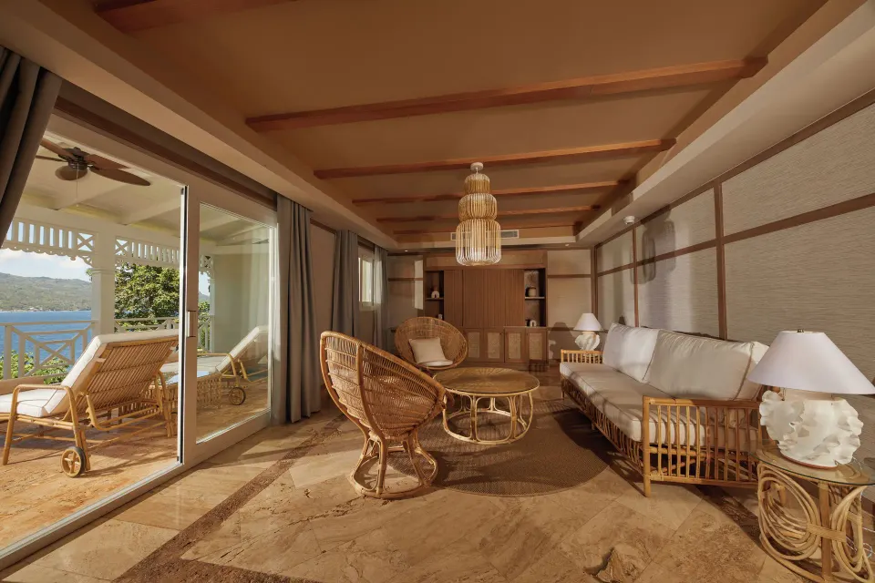 One Bedroom Villa living room with rattan seating and terrace view at Cayo Levantado Resort.