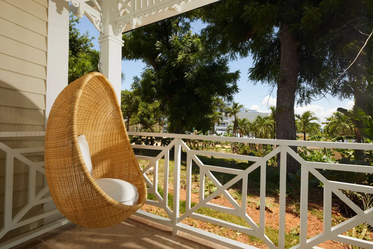 Villa 2 Bedrooms balcony with hanging wicker chair at Cayo Levantado Resort.