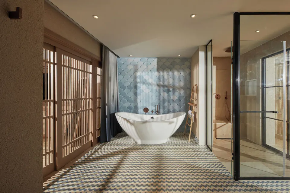 Oceanfront villa bathroom with soaking tub and glass shower at Cayo Levantado Resort.