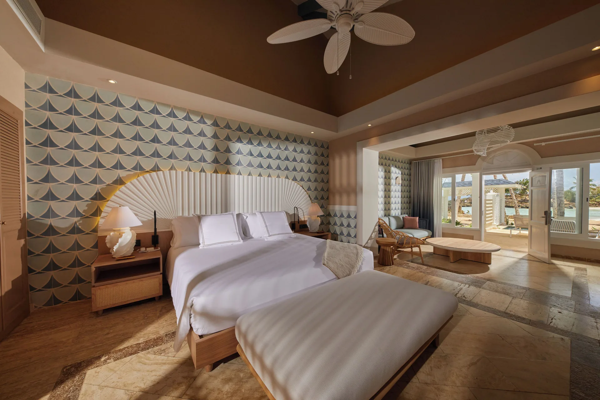 Oceanfront adults-only villa bedroom with king bed and terrace at Cayo Levantado Resort.