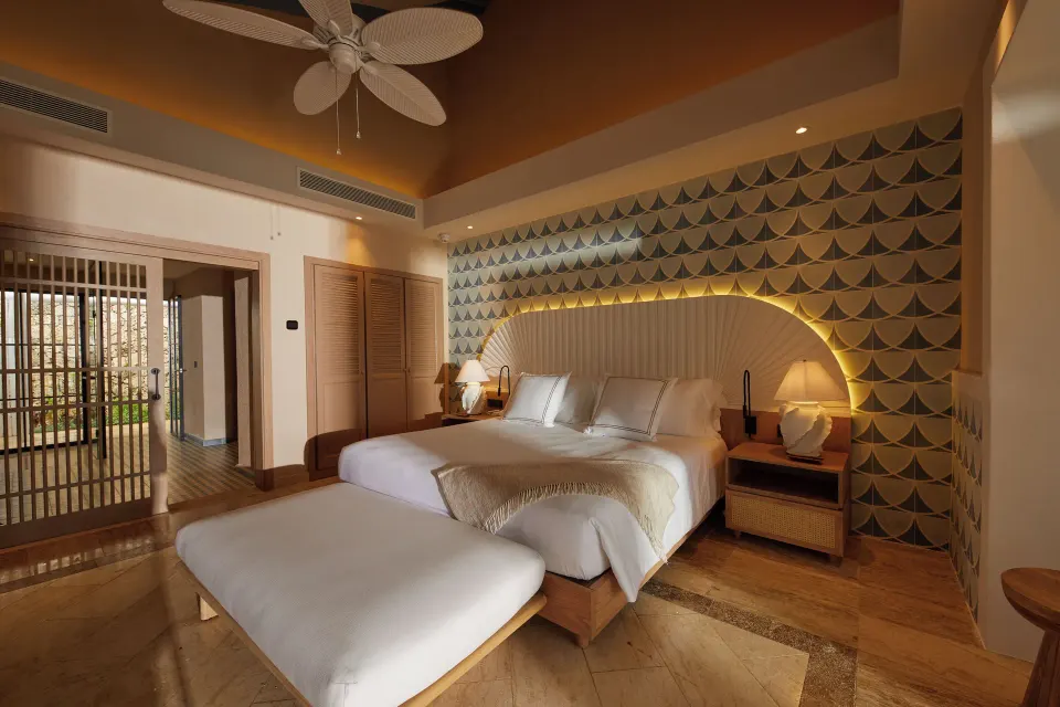 King bed, wardrobe, and entry area in an oceanfront adults-only villa at Cayo Levantado Resort.