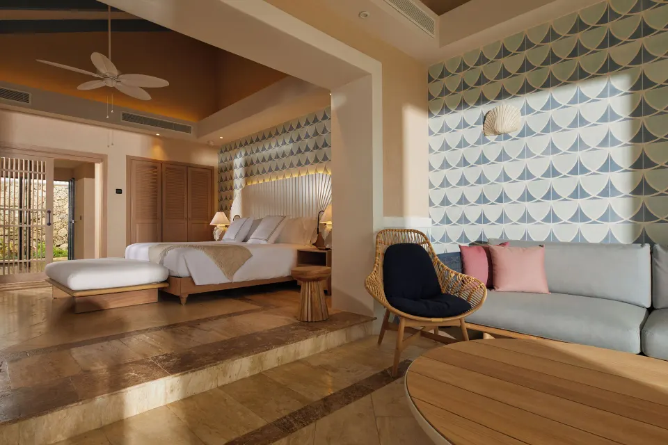 Oceanfront adults-only villa bedroom and sitting area at Cayo Levantado Resort.