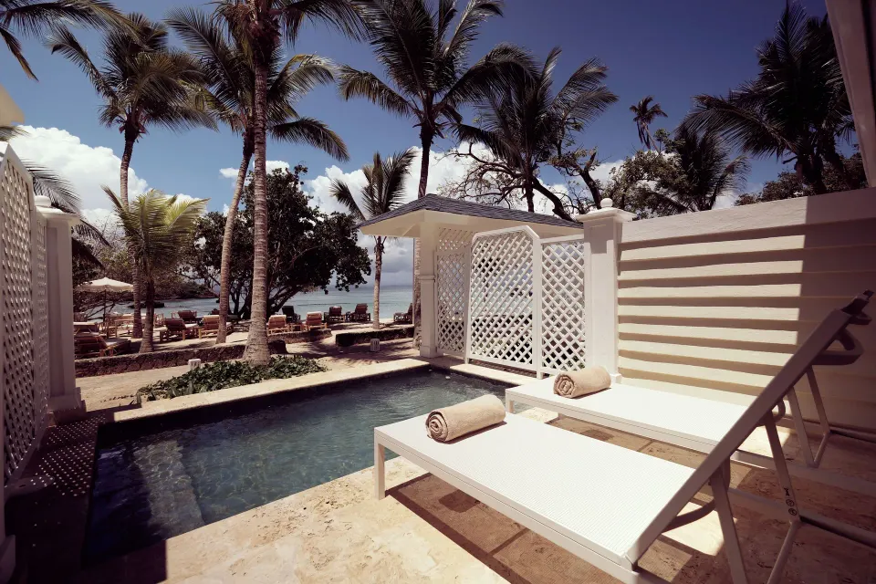 Private plunge pool terrace with loungers by the ocean at Cayo Levantado Resort.