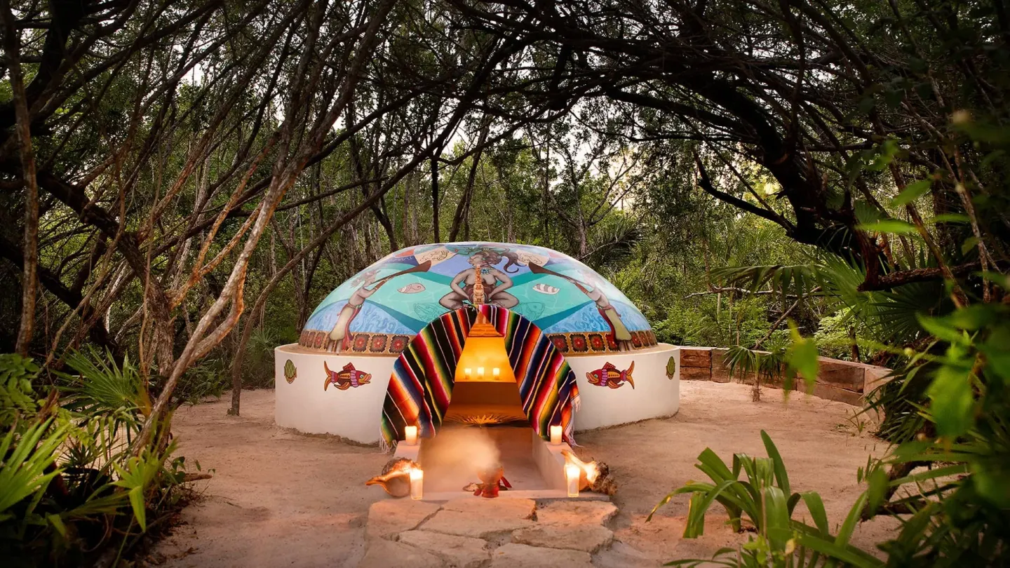 Colorfully painted temazcal structure in the jungle at Chablé Maroma.