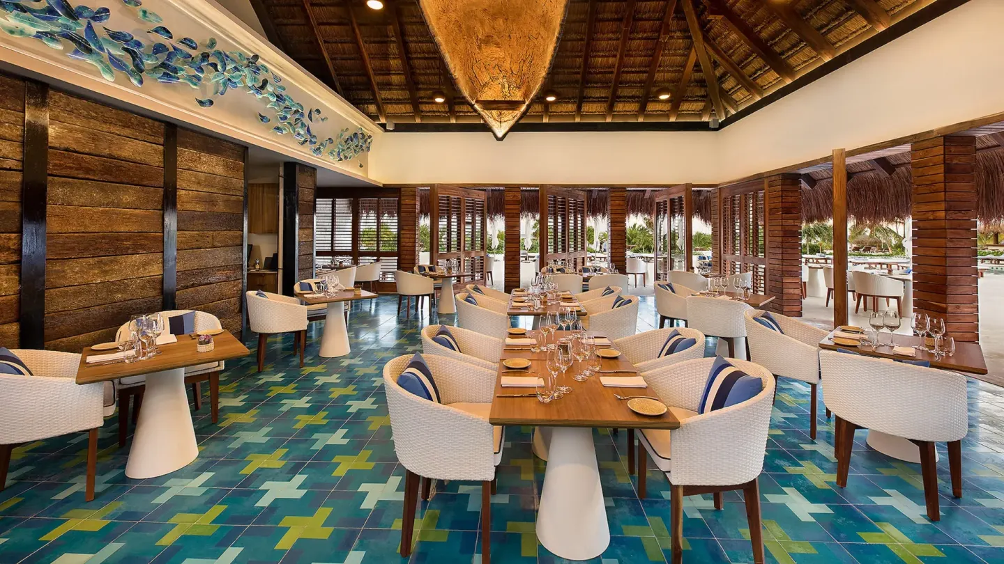 Bright restaurant dining room with blue tile floor at Chablé Maroma.