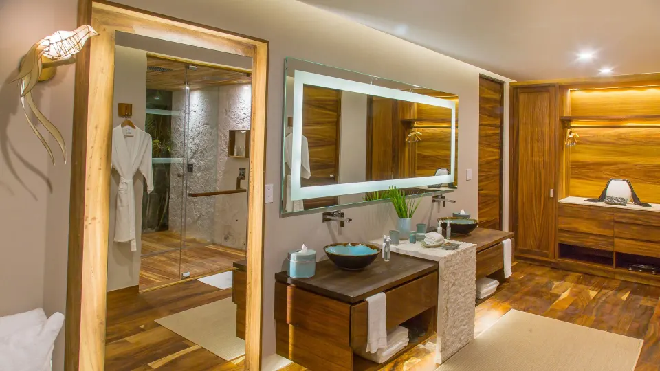 Treetop Pool Villa bathroom and dressing area with wood cabinetry at Chablé Maroma.