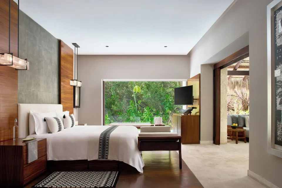 Treetop Pool Villa king bed with garden-facing window at Chablé Maroma.