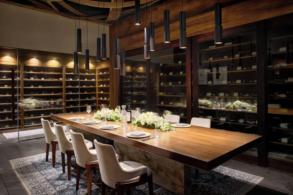 Private dining table in a wine-lined room at Chablé Maroma