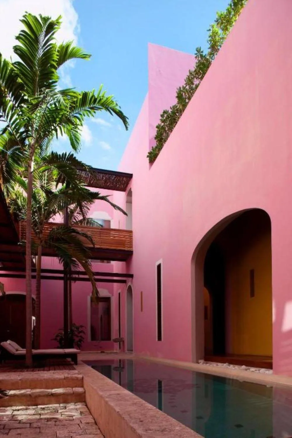 Rosas & Xocolate, Mérida design-forward boutique hotel with pink historic facade on Paseo de Montejo in Mérida, Mexico.