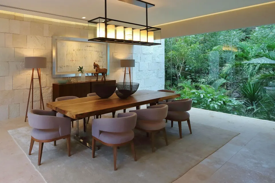 Indoor-outdoor dining table overlooking a verdant garden at Chablé Yucatán
