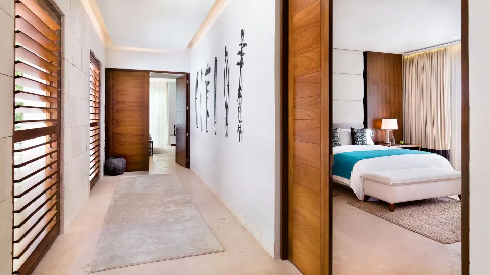 Entry corridor and bedroom doorway of a guest room at Chablé Yucatán