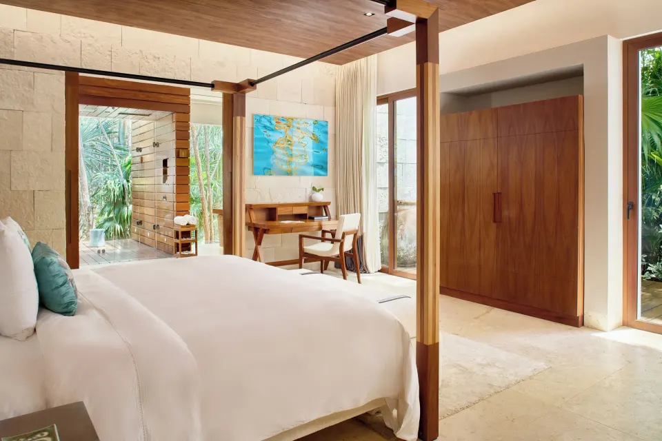 King bedroom with four-poster bed and desk at Chablé Yucatán