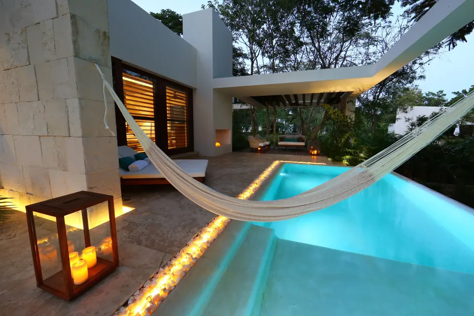 Evening private pool with hammock and candle lanterns at Chablé Yucatán