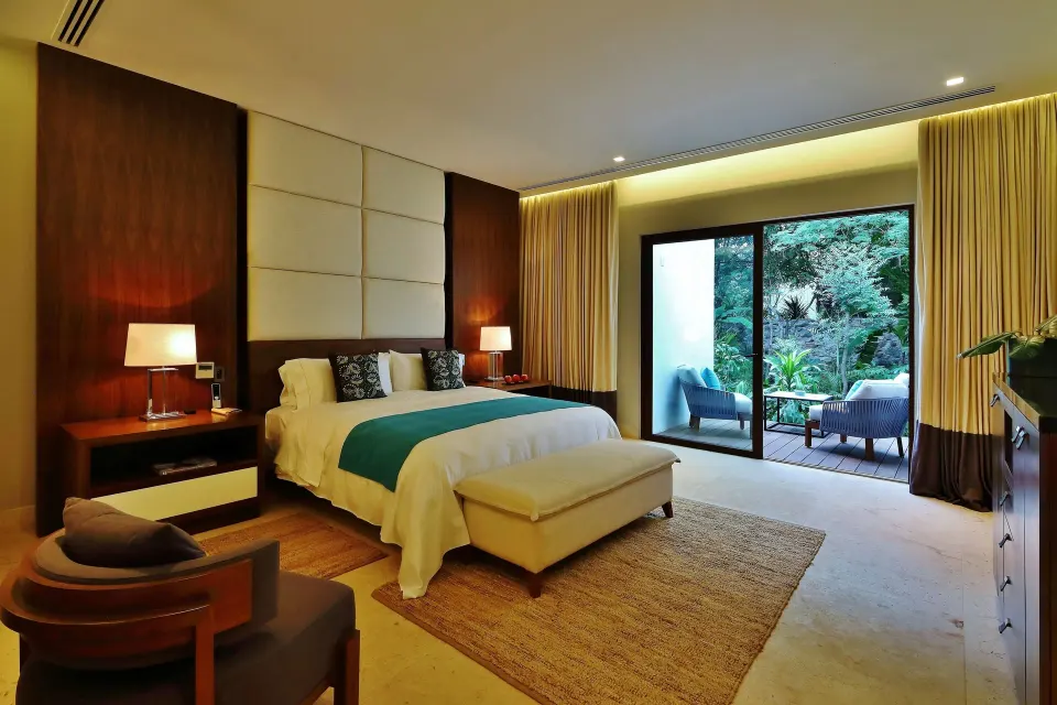 Spacious guest bedroom with king bed and terrace at Chablé Yucatán